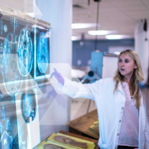 scientist pointing to MRI images on a wall